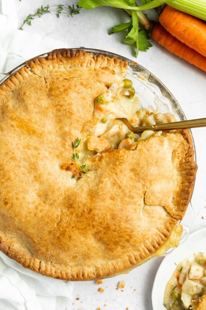 chicken pot pie in pie dish with a slice removed
