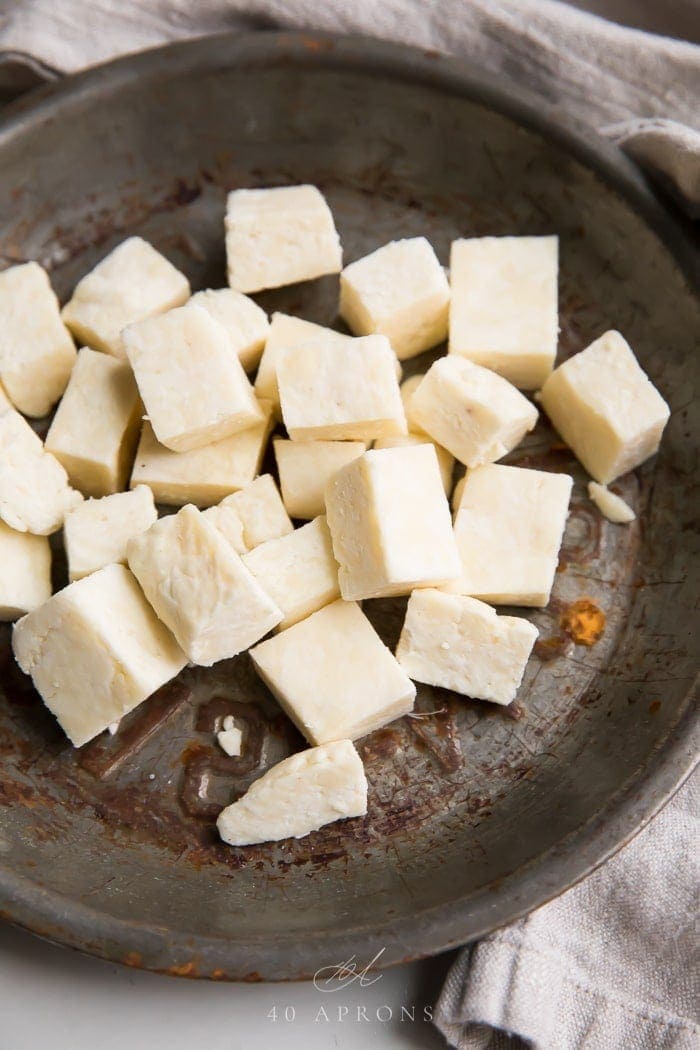 Cubes of paneer Indian cheese in a metal dish