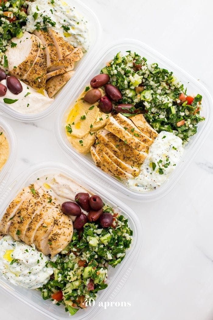 This Greek healthy meal prep recipe is epic: cauliflower rice tabbouleh, tender seasoned chicken breasts, hummus or baba ganoush, kalamata olives, and a rich, garlicky tzatziki. This healthy meal prep recipe will have you looking forward to lunch all morning! It's also a Whole30 meal prep recipe and paleo meal prep recipe, too, when you sub coconut cream or coconut yogurt for the yogurt. This is seriously SUCH a perfect healthy meal prep recipe.