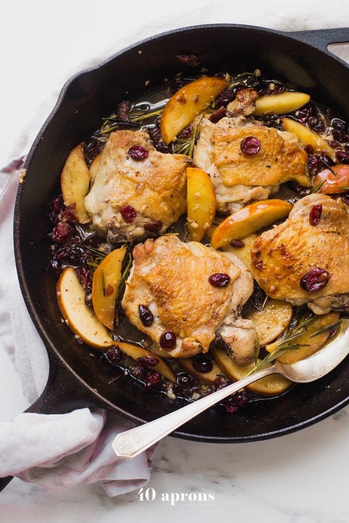 These paleo cranberry apple chicken thighs with rosemary are such a delicious paleo fall recipe. With organic cranberry juice and dried cranberries, these paleo cranberry apple chicken thighs are an easy and quick paleo dinner that's elegant enough for company.
