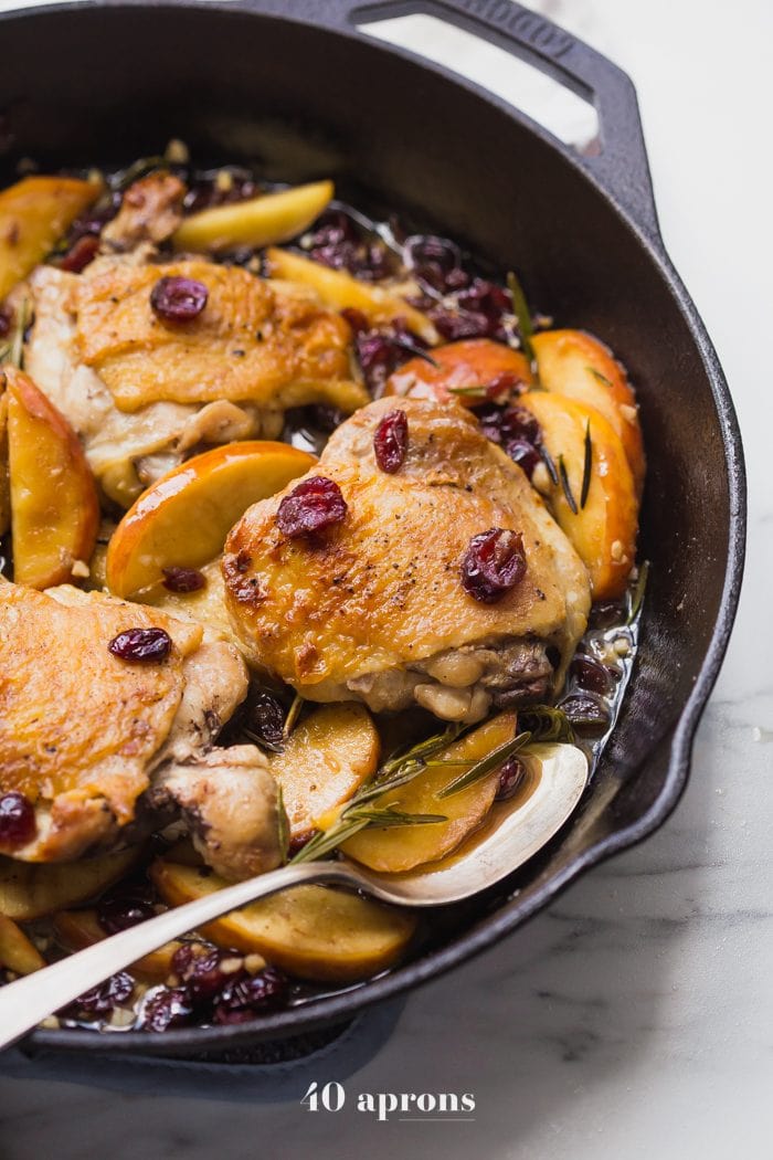 These paleo cranberry apple chicken thighs with rosemary are such a delicious paleo fall recipe. With organic cranberry juice and dried cranberries, these paleo cranberry apple chicken thighs are an easy and quick paleo dinner that’s elegant enough for company. 