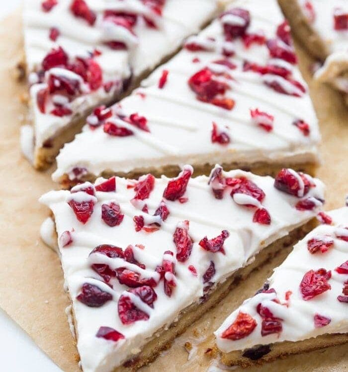 These paleo cranberry bliss bars are just that: bliss! These vegan cranberry bliss bars are a grain-, gluten-, and dairy-free paleo Starbucks copycat recipe that's perfect for the holidays. Blondies, layered with "cream cheese" frosting, topped with dried cranberries, these paleo cranberry bliss bars are so delicious. You'll love these vegan cranberry bliss bars because they're a holiday treat that are totally guilt-free!