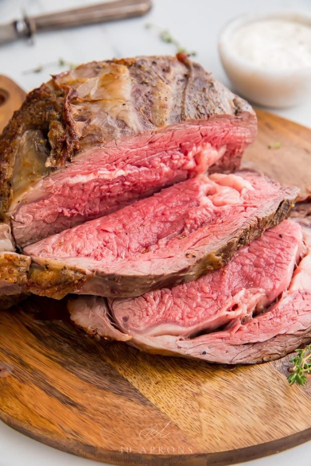 Roasted prime rib in slices on a wooden board