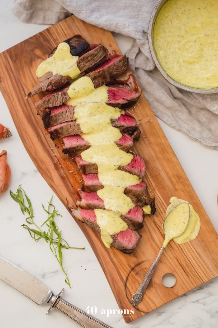 Medium-rare Whole30 steak with Whole30 bearnaise sauce in a dish