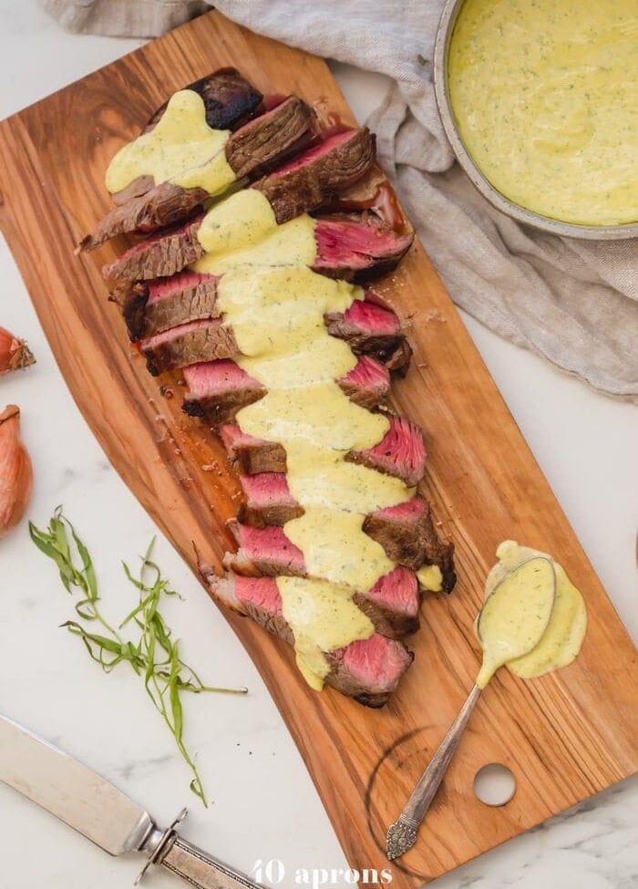 Medium-rare Whole30 steak with Whole30 béarnaise sauce in a dish