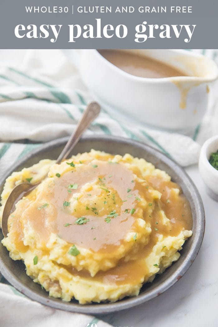 creamy mashed potatoes topped with a rich gravy in a grey bowl