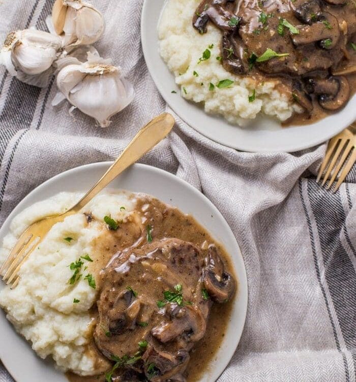Overhead shot of Whole30 Salisbury Steak served with mashed potatoes and sprinkled with chives