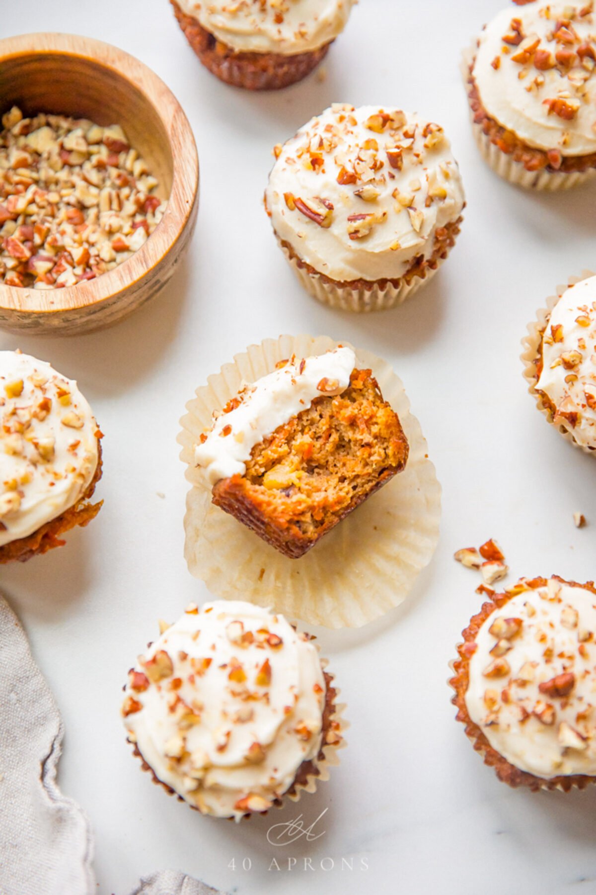 Top-down view of frosted and unfrosted paleo carrot cake cupcakes.