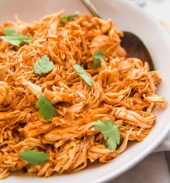 Shredded Mexican chicken in a white bowl