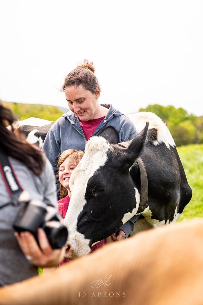 Farmer and her daughter hugging a cow at Wonder Why Farm in Vermont