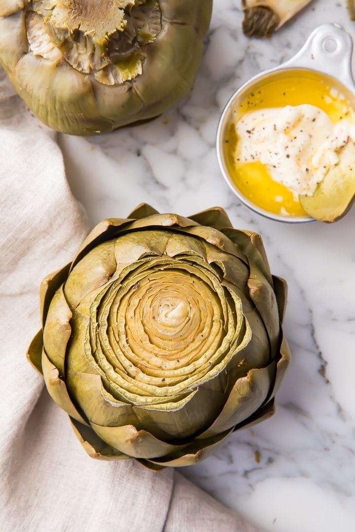 An instant pot artichoke on a marble work surface