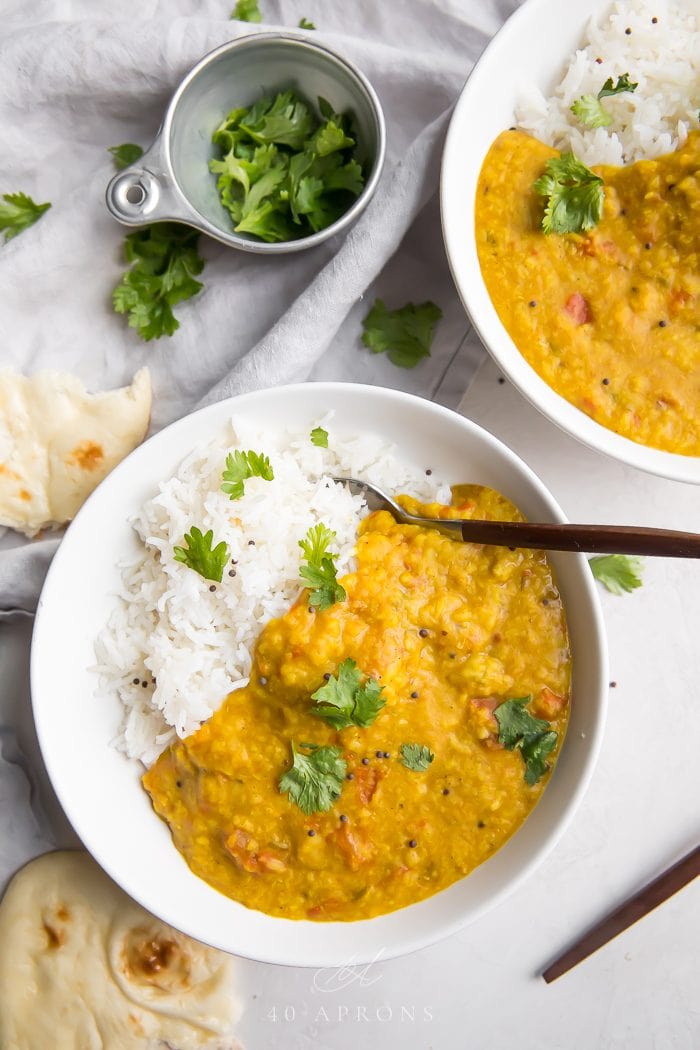 Two bowls of instant pot dal served with rice