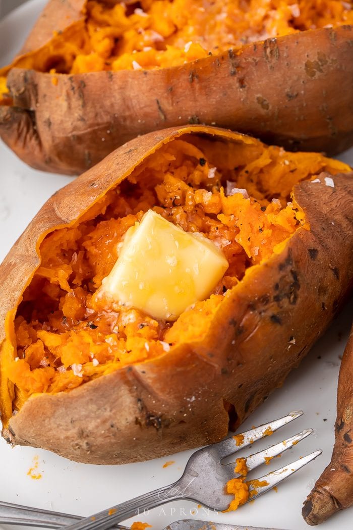 An instant pot sweet potato served with butter