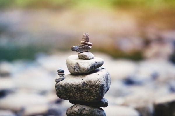 a pile of different sized stones and pebbles stacked on top of each other in a zen garden