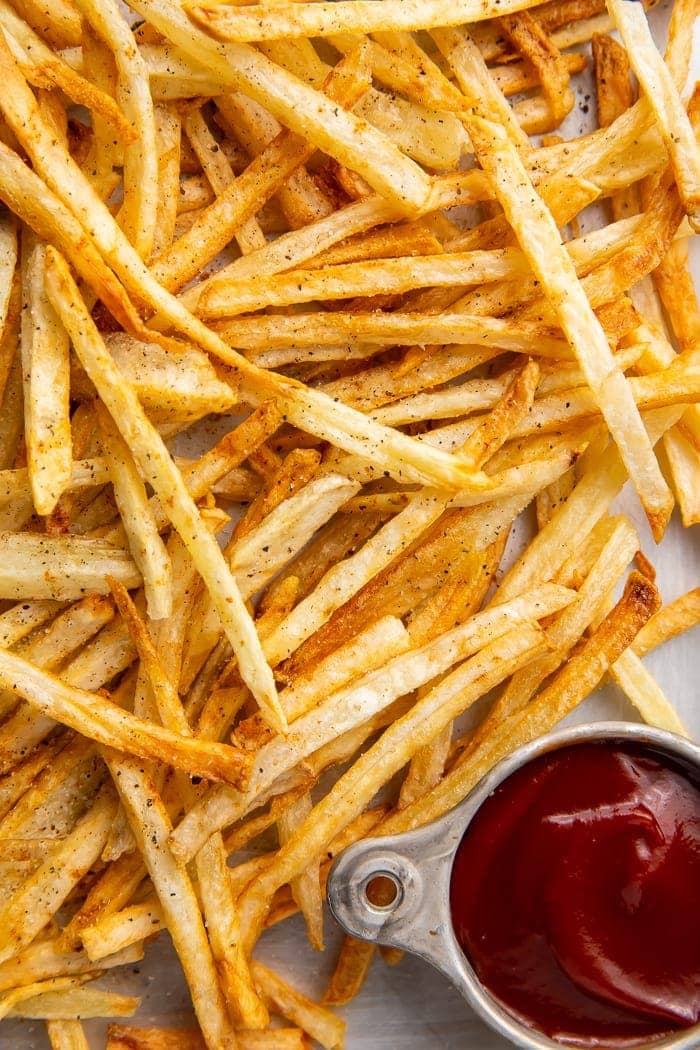 Close-up of air fryer french fries with a side of ketchup