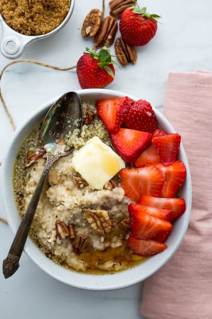 Oatmeal with pecans, butter, and strawberries