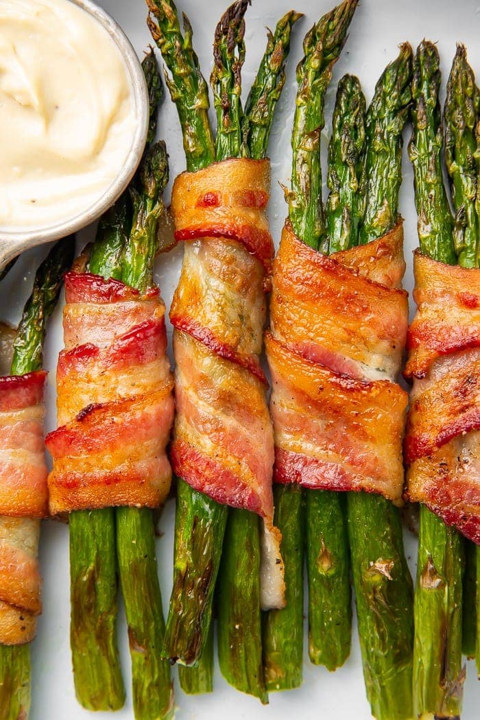 Whole30 asparagus wrapped in bacon served with garlic aioli