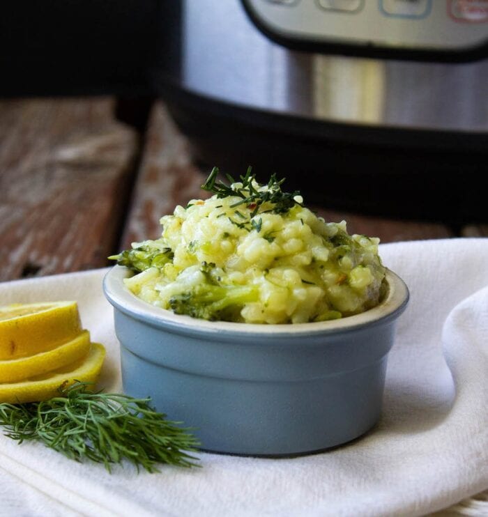 Blue bowl holding vegan Instant Pot broccoli lemon risotto