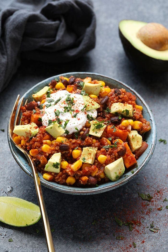 Vegetarian crockpot mexican quinoa in a grey bowl with a fork