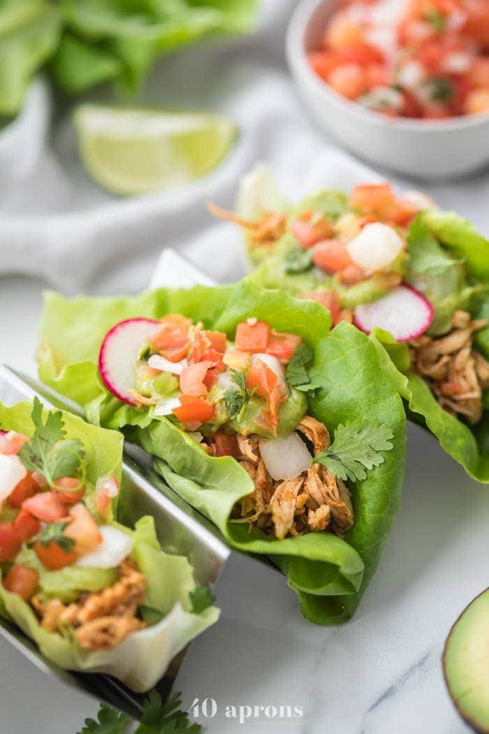 Low carb chicken and lettuce tacos in a silver metal taco holder