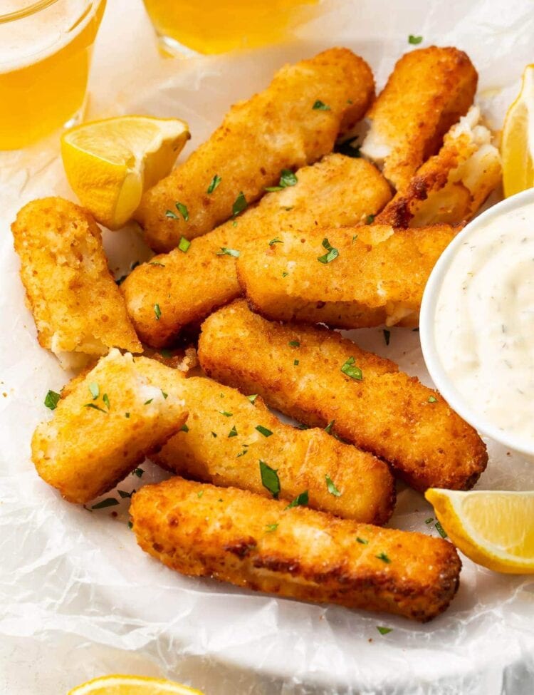 Air fried fish sticks on a white plate with dipping sauce