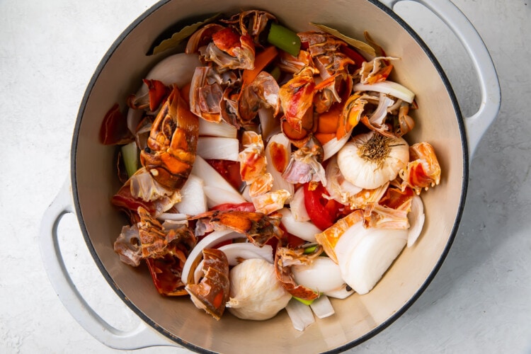 Lobster shells, onion, garlic, and vegetables in a large pot