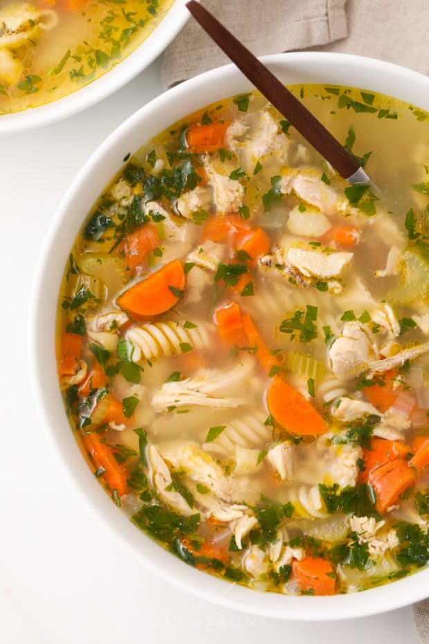Gluten free chicken noodle soup in a white bowl