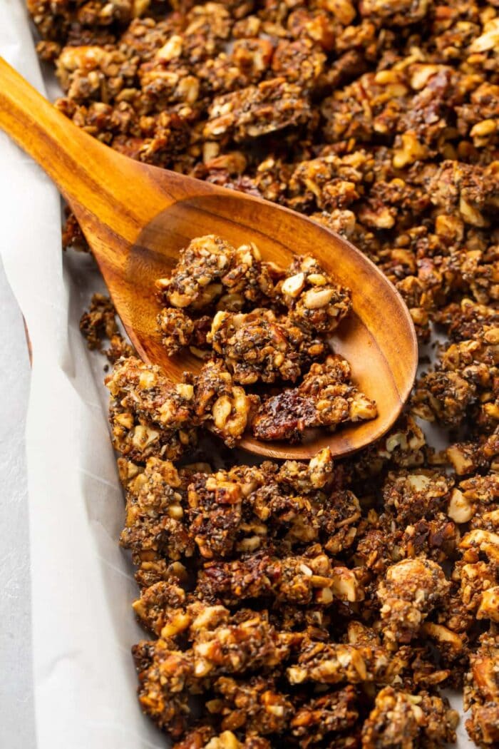 Keto granola with chia seeds and collagen on a baking sheet lined with parchment paper
