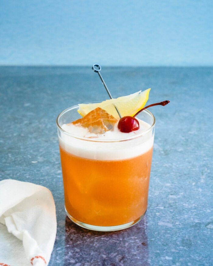 A classic amaretto sour with an egg white foam and cherry garnish