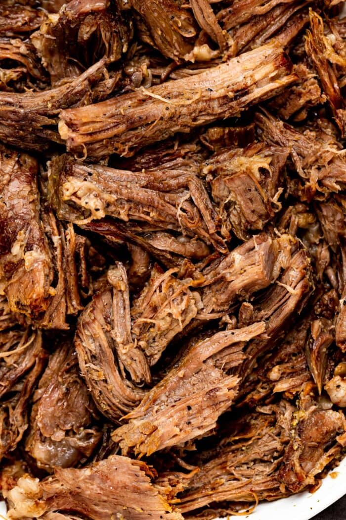 Close up image of shredded beef in a bowl.