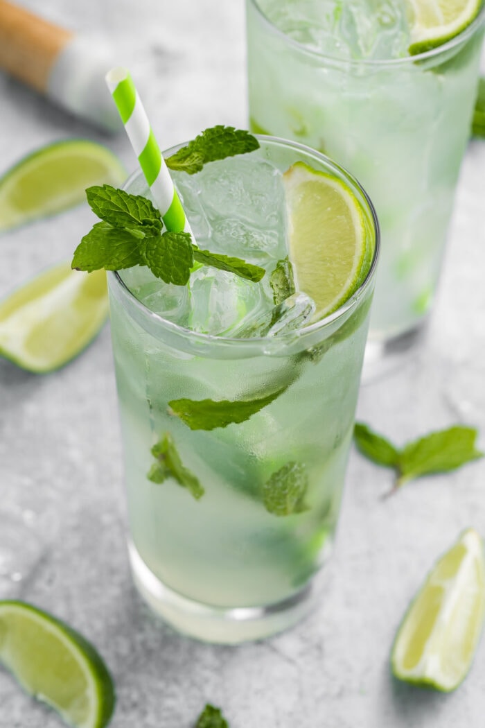 Virgin mojito in a tall glass with a green striped straw