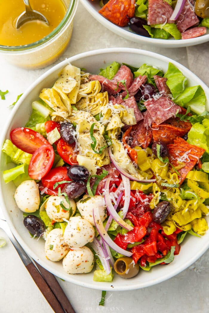 Antipasto salad in a large white bowl, taken from above.
