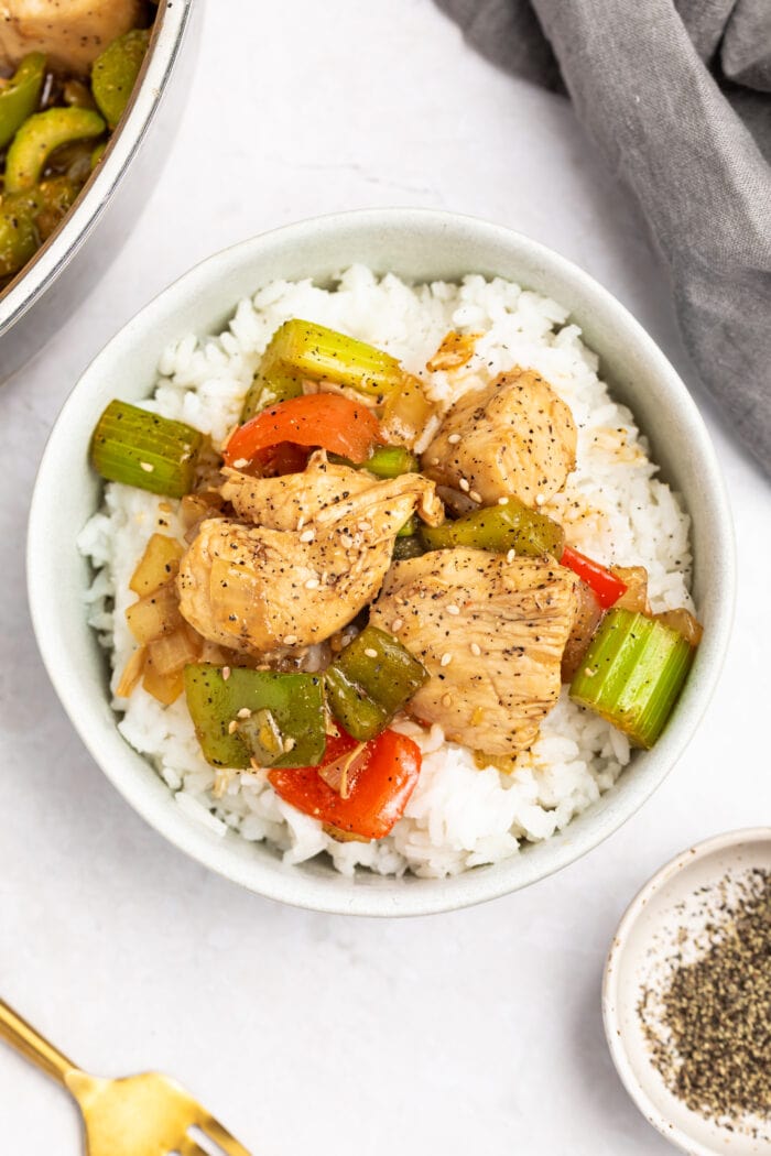 black pepper chicken in a bowl over rice