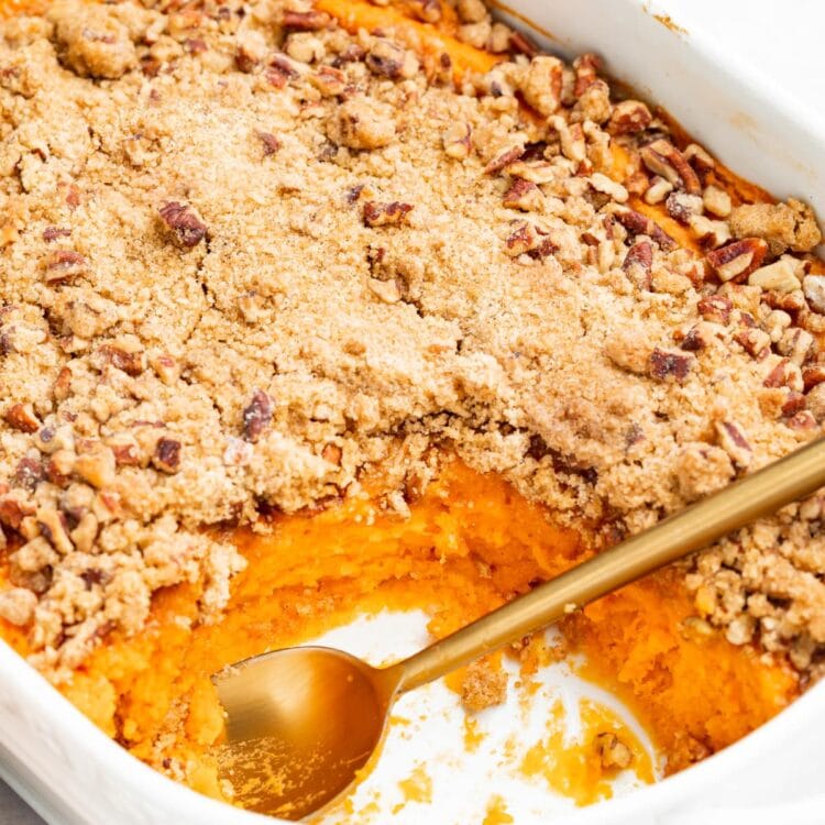 sweet potato souffle in a baking dish with a spoon