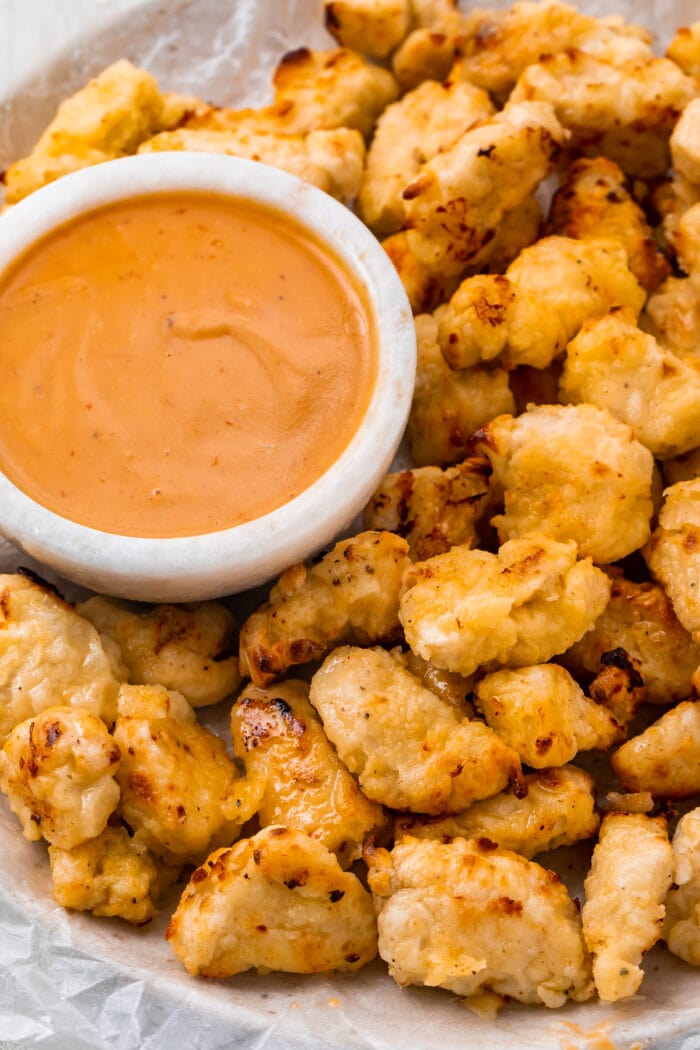 Air fryer chicken nuggets next to a bowl of Chick-fil-a sauce