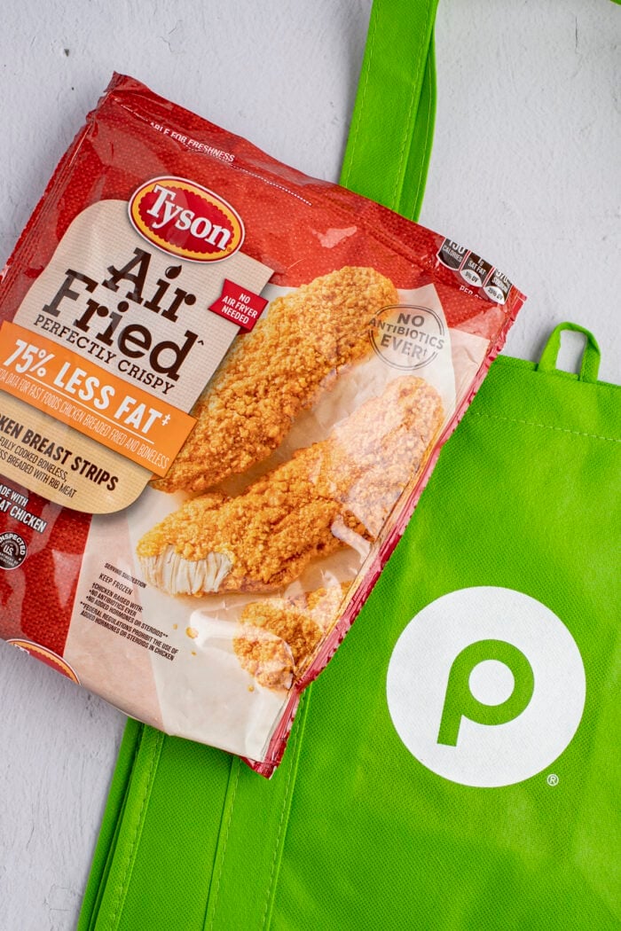 Tyson air fried chicken strips packaging with a Publix reusable shopping bag