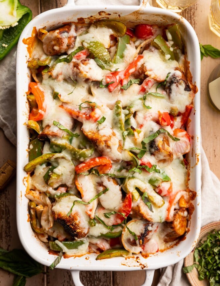 Overhead view of cheesy Italian sausage and bell pepper casserole in a white casserole dish.