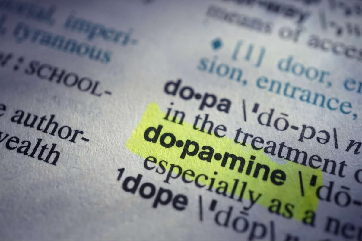 The word "dopamine" highlighted in neon yellow in the dictionary.
