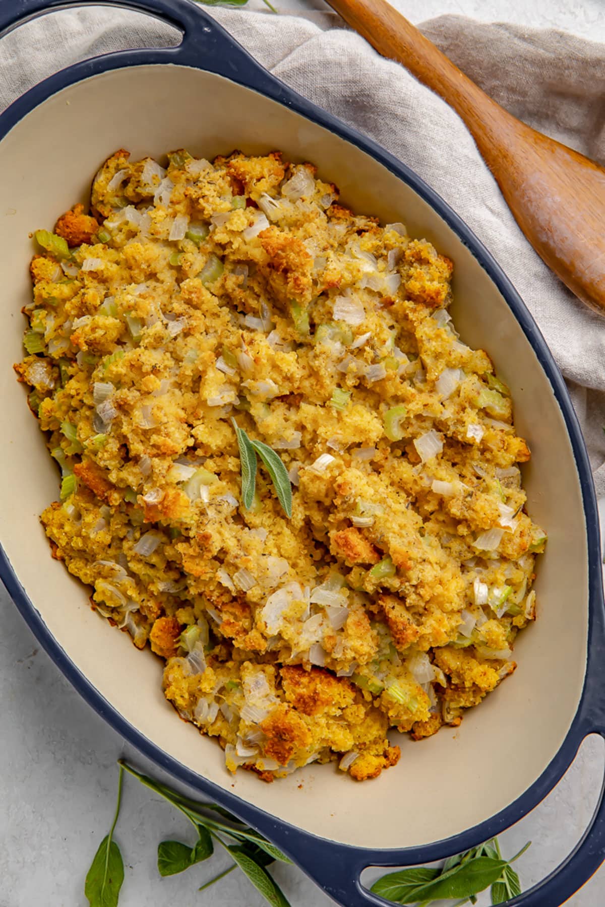 Overhead view of cornbread stuffing in a large blue casserole dish.